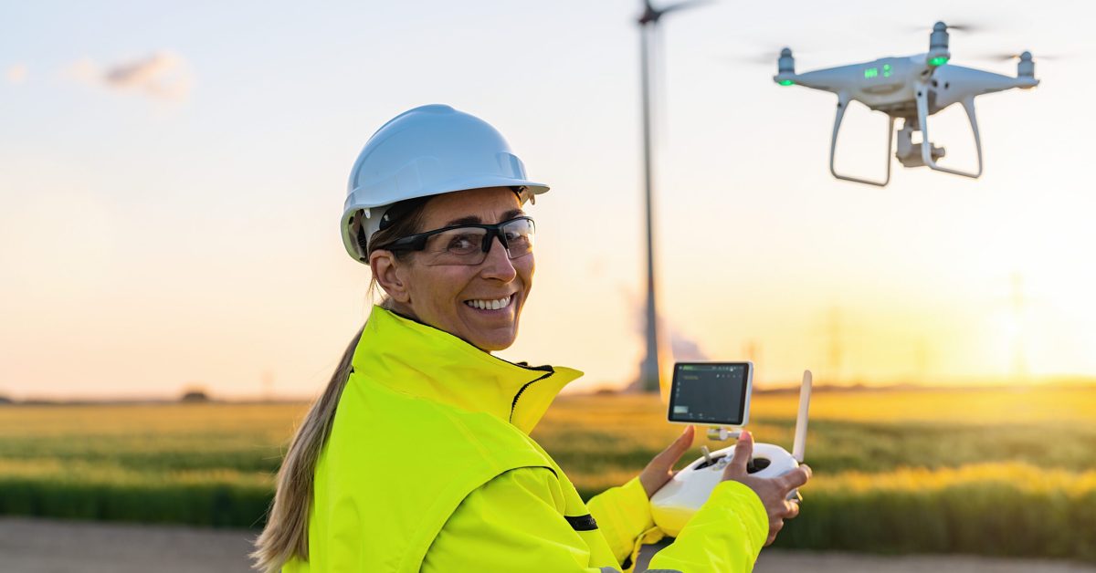 Woman construction project manager flies drone on project site