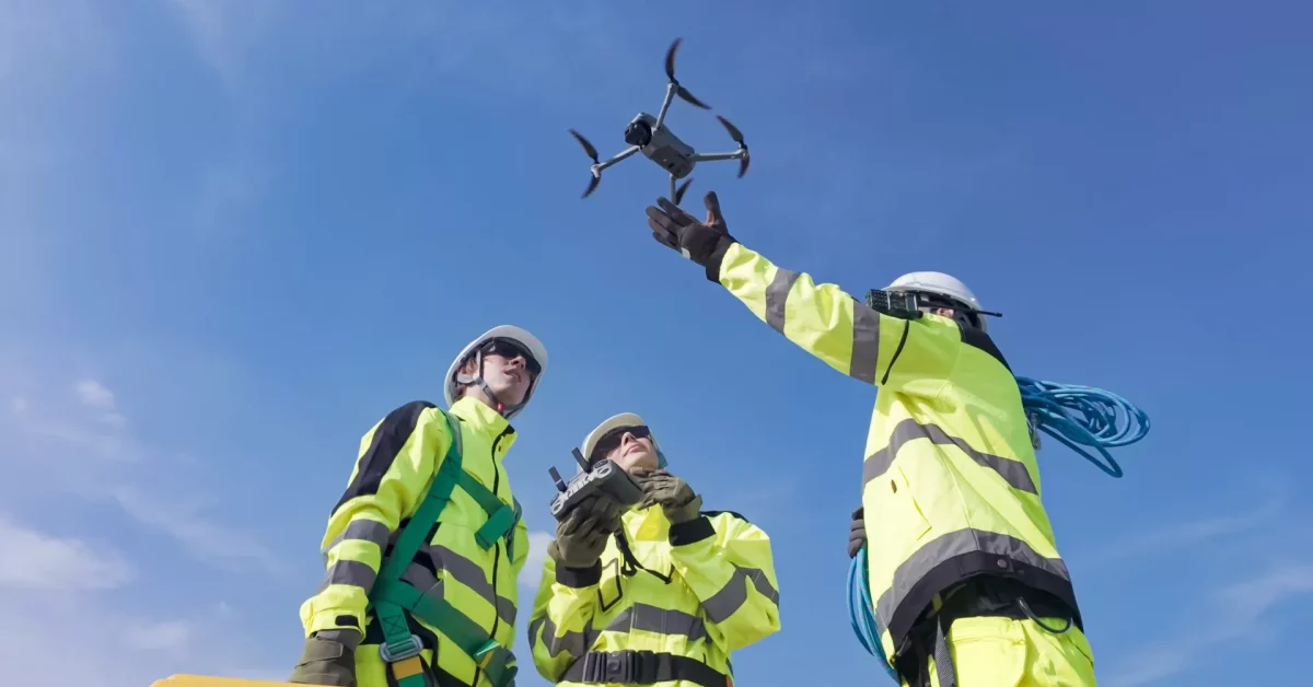 Construction workers with aerial drone on construction site
